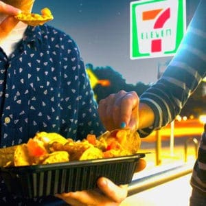 Couple eating nachos outside of 7-Eleven store