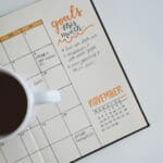 Cup of coffee sitting on planner