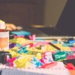 Crumpled sticky notes and mug on table