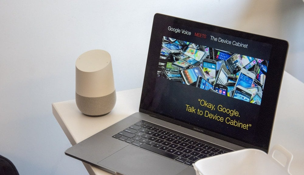 MacBook and Google Home sitting on table
