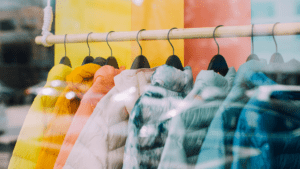 Colorful jackets hanging behind a window