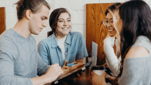Group of four people talking while on iPad
